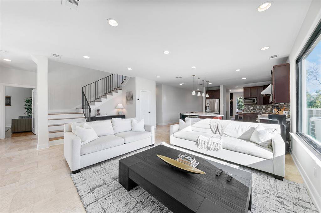 The vast open floor plan and clean architectural lines provide the ultimate in flexible living, with all common areas seamlessly flowing together, creating a spacious and inviting environment for both daily living and entertaining.