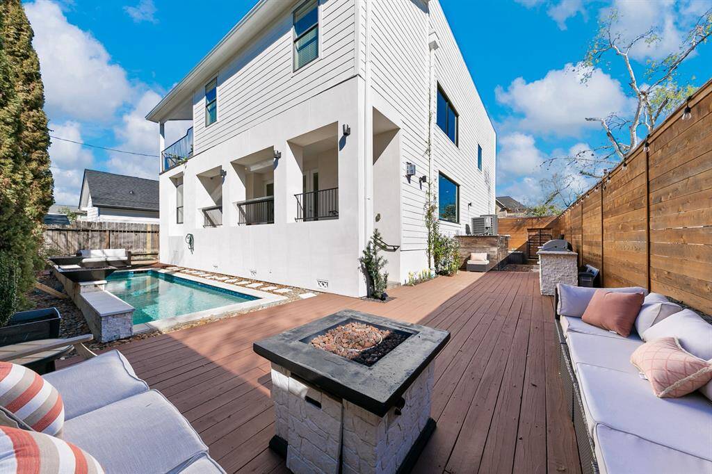 Brilliantly designed, this home does not sacrifice its striking aesthetics in creating a cozy, inviting backyard oasis complete with covered balconies upstairs and down overlooking the heated pool, lounge areas, and outdoor kitchen.