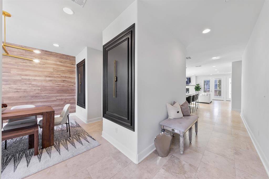 Luxurious travertine flooring throughout the first-floor common areas creates clean, open lines offering a contemporary gallery-like interior.