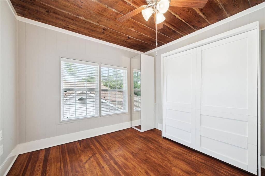 Another view of the secondary bedroom offering murphy bed and wardrobes.