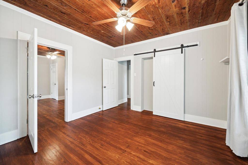 Another view of the front bedroom with sliding door to small closet