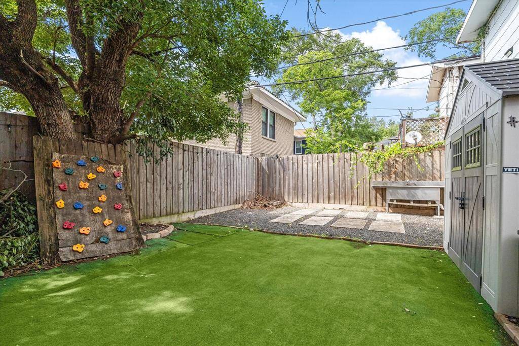 Shared private fully fenced yard area with outdoor sink and storage area.