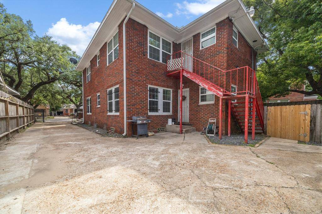 The red staircase offers a back entrance to the second floor unit