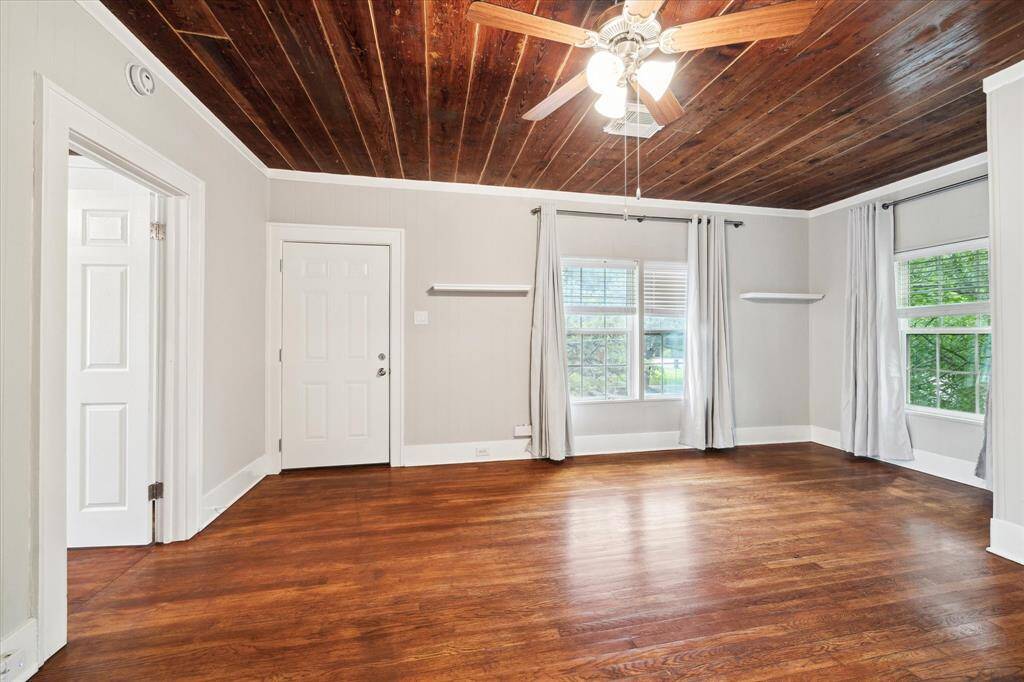 The view walking into the living room. This space could serve as a flex area for living plus small office area. The door to the left leads to a room, the door in front leads to the private balcony.