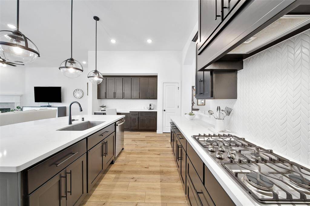 Style meets funcation in this streamlined Kitchen including GE Appliances.