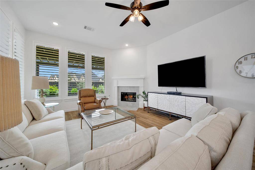 The room boasts a charming corner gas fireplace, adding warmth and ambiance.