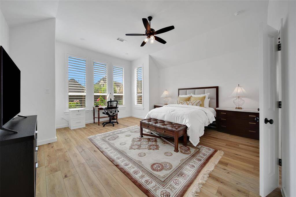 Inviting primary suite has a cozy bump-out area, perfect for a sitting nook or a dedicated workspace.