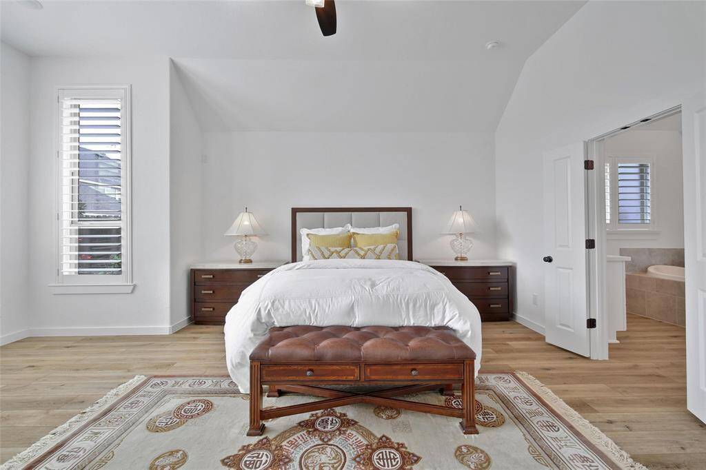 The primary bedroom features impressive volume ceilings, enhancing the sense of space and openness.