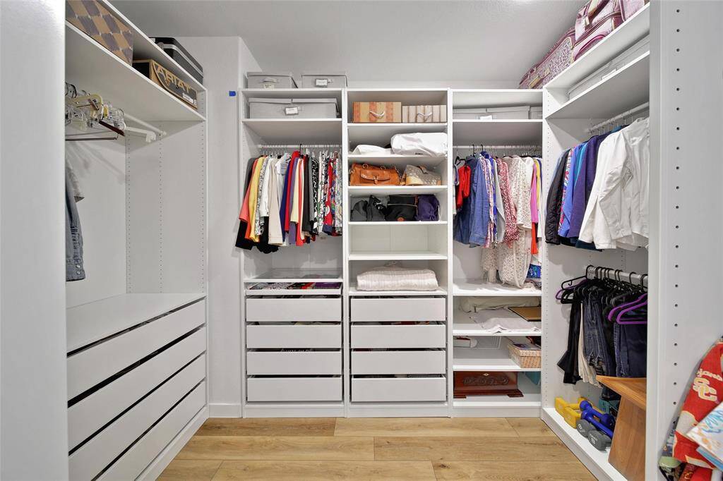 The custom-built closet is thoughtfully designed with a place for everything, featuring tailored shelving, drawers, and hanging space to keep your wardrobe perfectly organized.