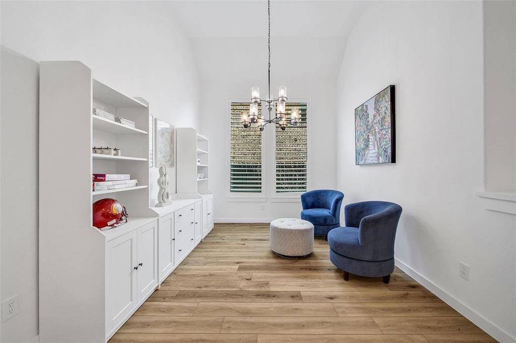 The formal dining area (currently being used as a sunroom/playroom) boasts a designer inspired chandelier that illuminates the room creating a sophisticated ambiance.