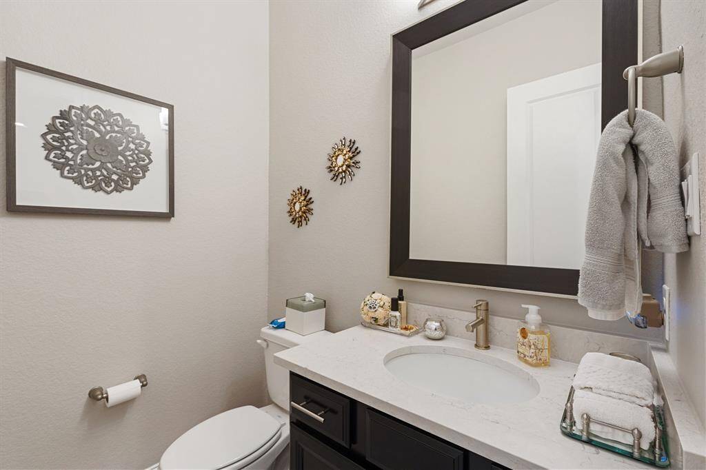 This convenient half bathroom is ideal for guests, offering a stylish and functional space with a modern vanity and clean design.