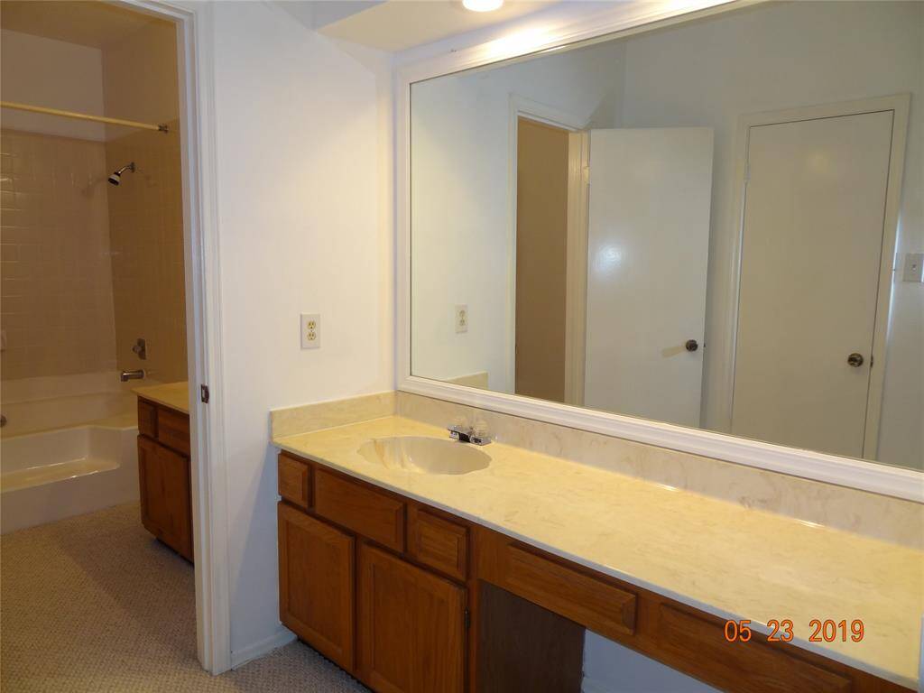 Primary bathroom has 2 separate vanity areas with framed mirrors.
