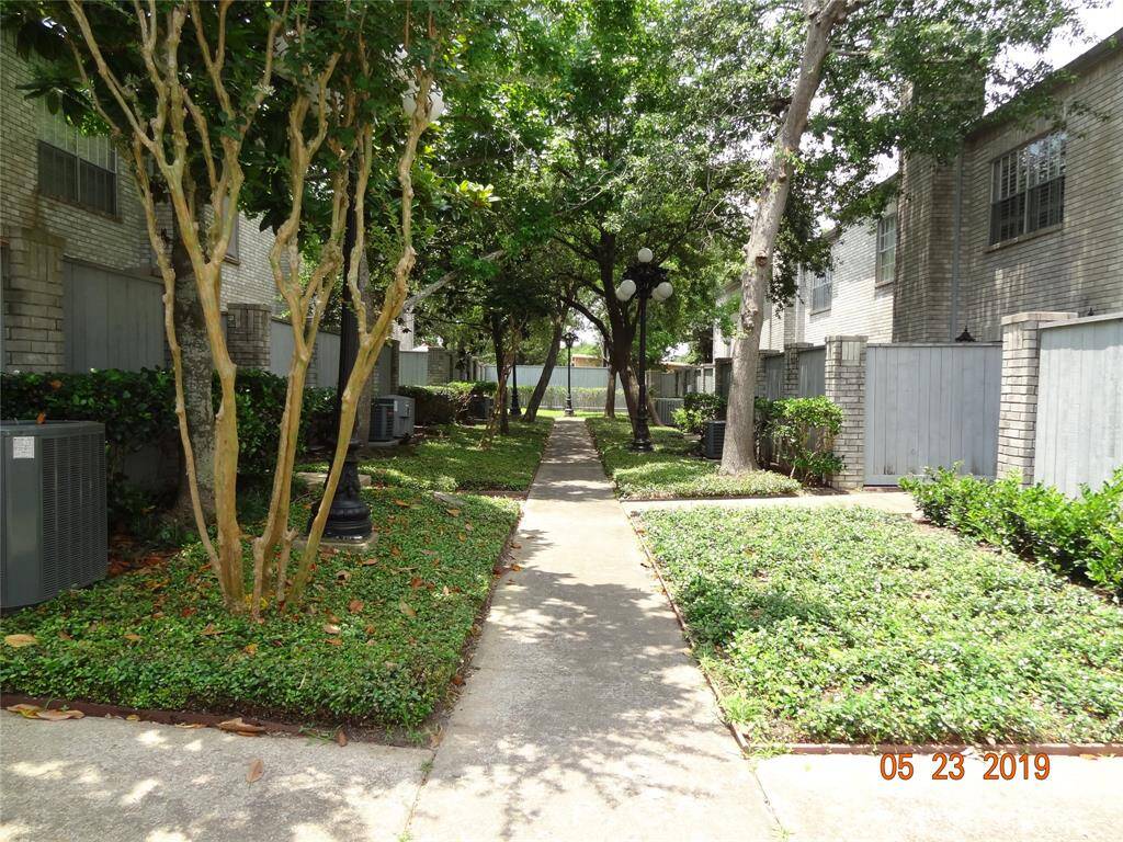 Walkway to unit from driveway (where there is additional parking). Unit is the last section to the right of the walkway.