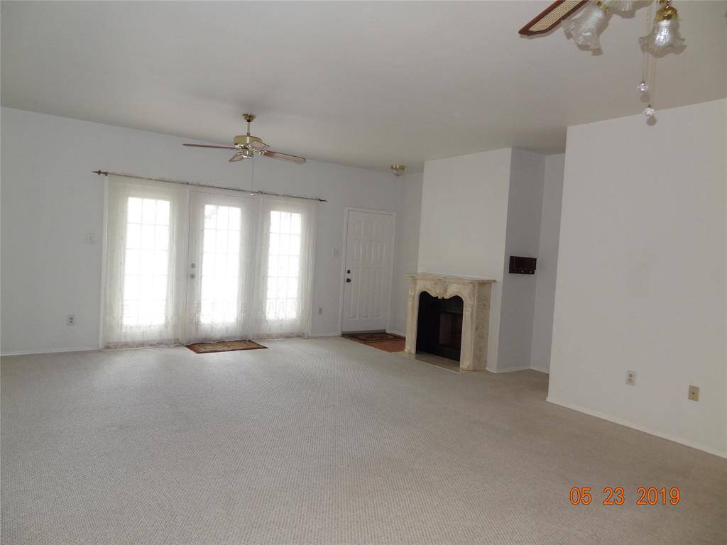 View of Living room & entry from Dining Area. Pretty fireplace & french doors leading to patio