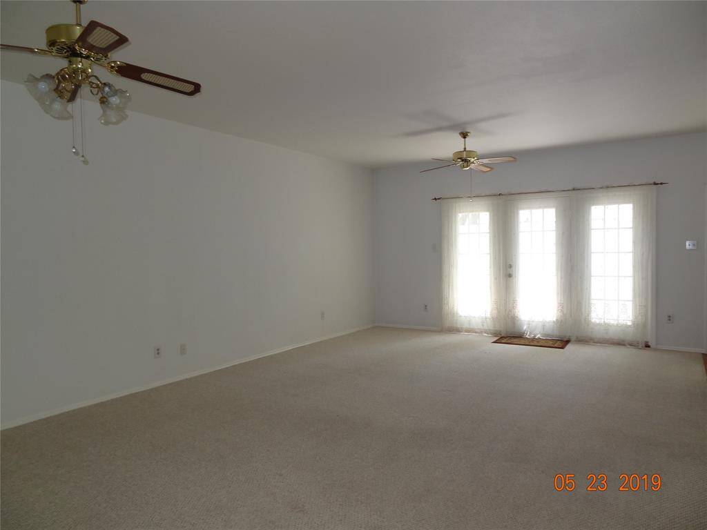 Spacious Living Dining room combo with 2 ceiling fans .