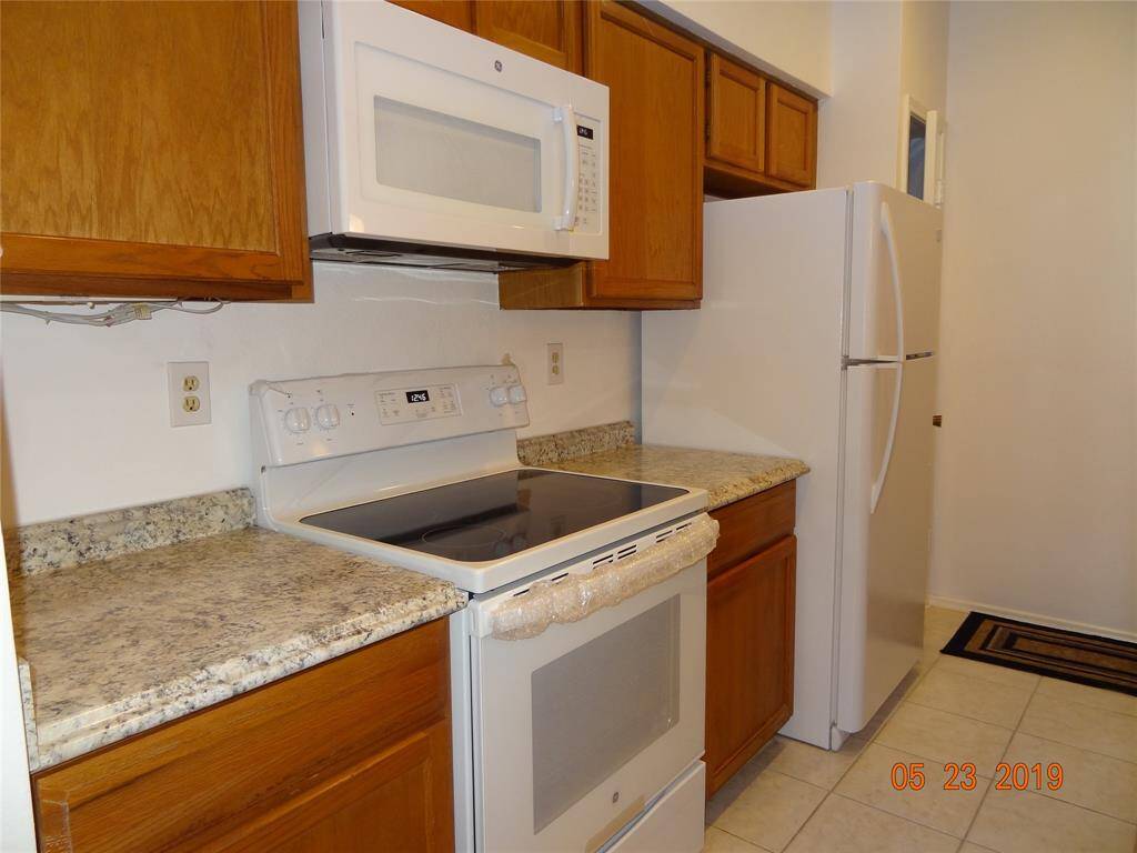 Appliances include refrigerator.  Pantry is to the right of the fridge.