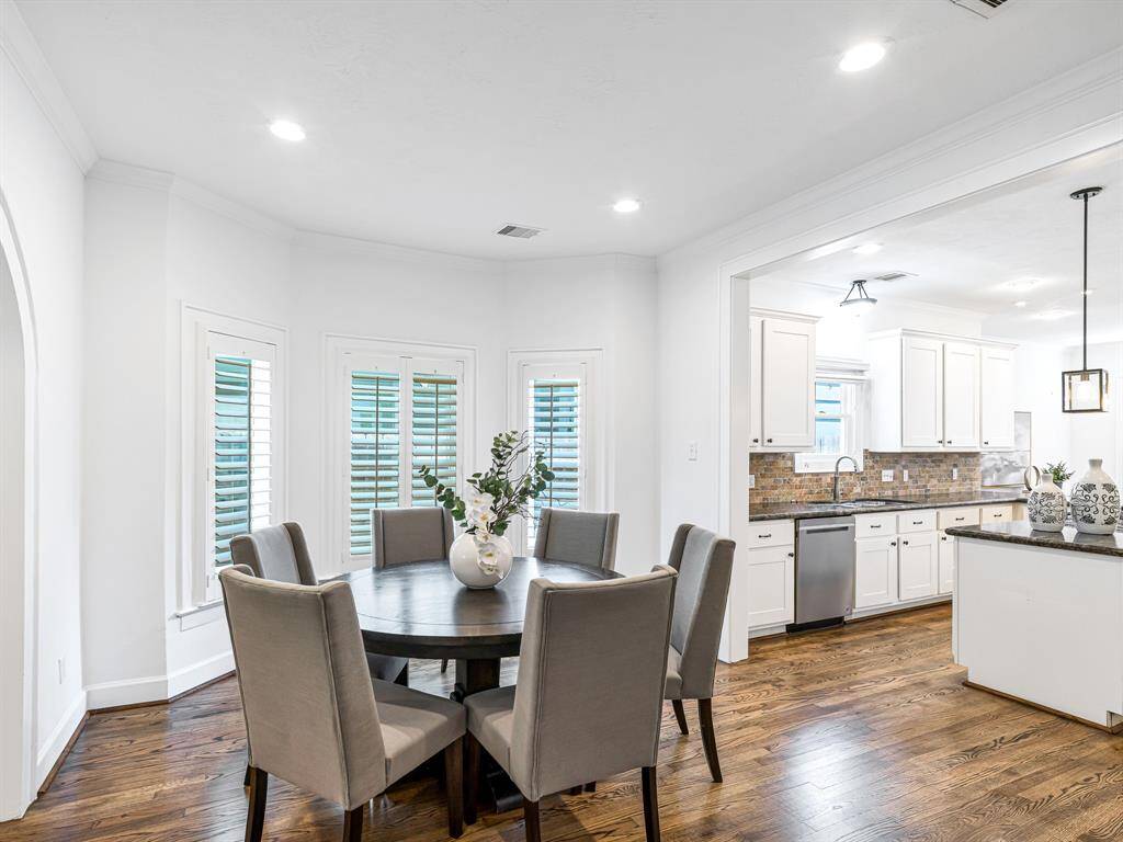 A charming bay window, accented with plantation shutters, brings character and natural light to the room.