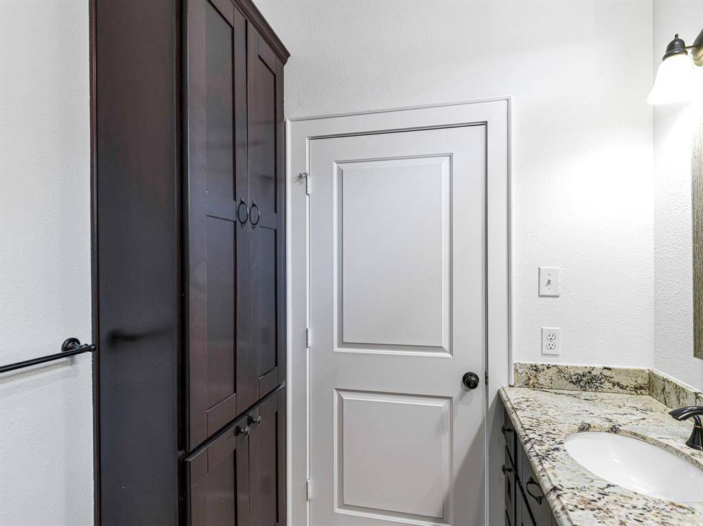 A linen closet opposite the dual vanity provides extra storage.