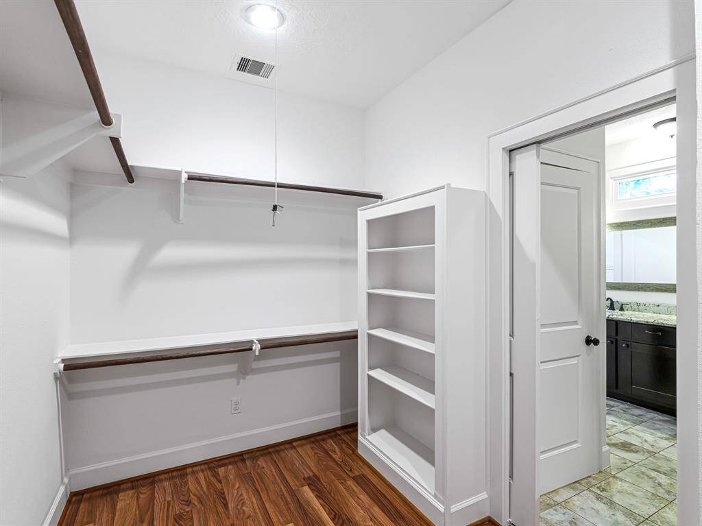 Behind a pocket door, the spacious walk-in closet offers plenty of storage.