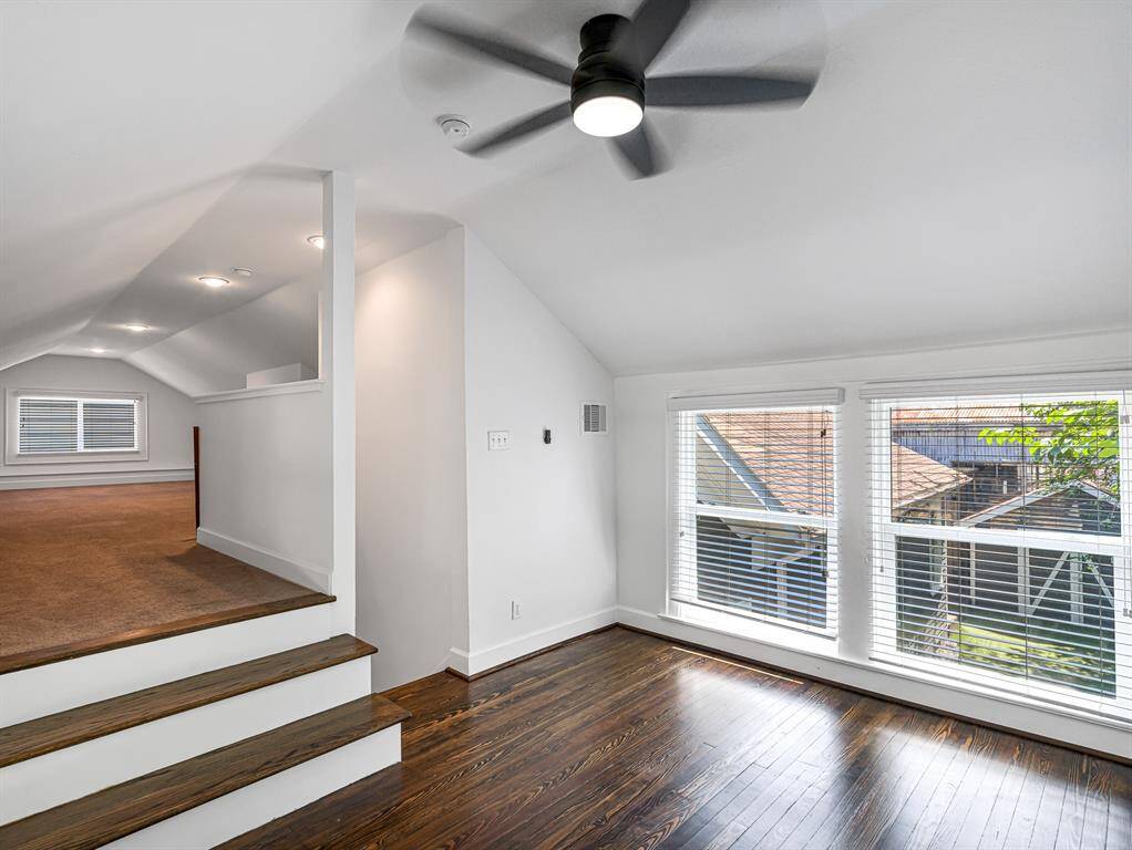 This bonus space features original windows, wood flooring, and a ceiling fan, adding character and comfort.
