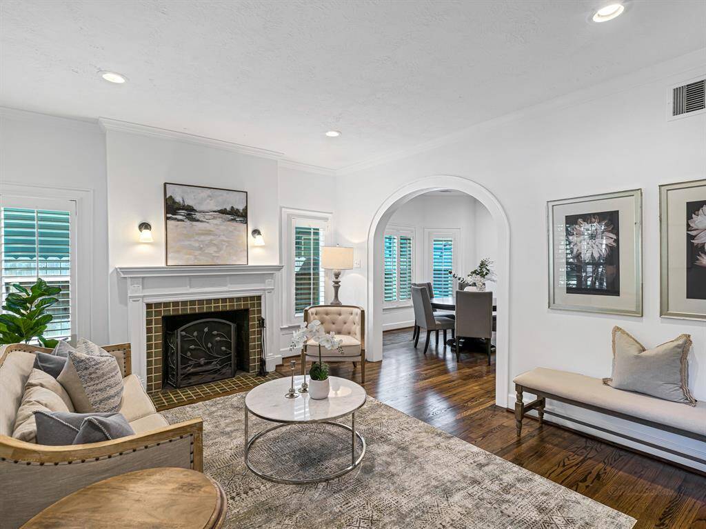 From the moment you step through the front door, you’ll be captivated by the home’s custom details. Wood floors, 6-inch baseboards, plantation shutters, and crown molding flow seamlessly from the entry into the dining room, kitchen, and den, creating a cohesive and elegant living space.