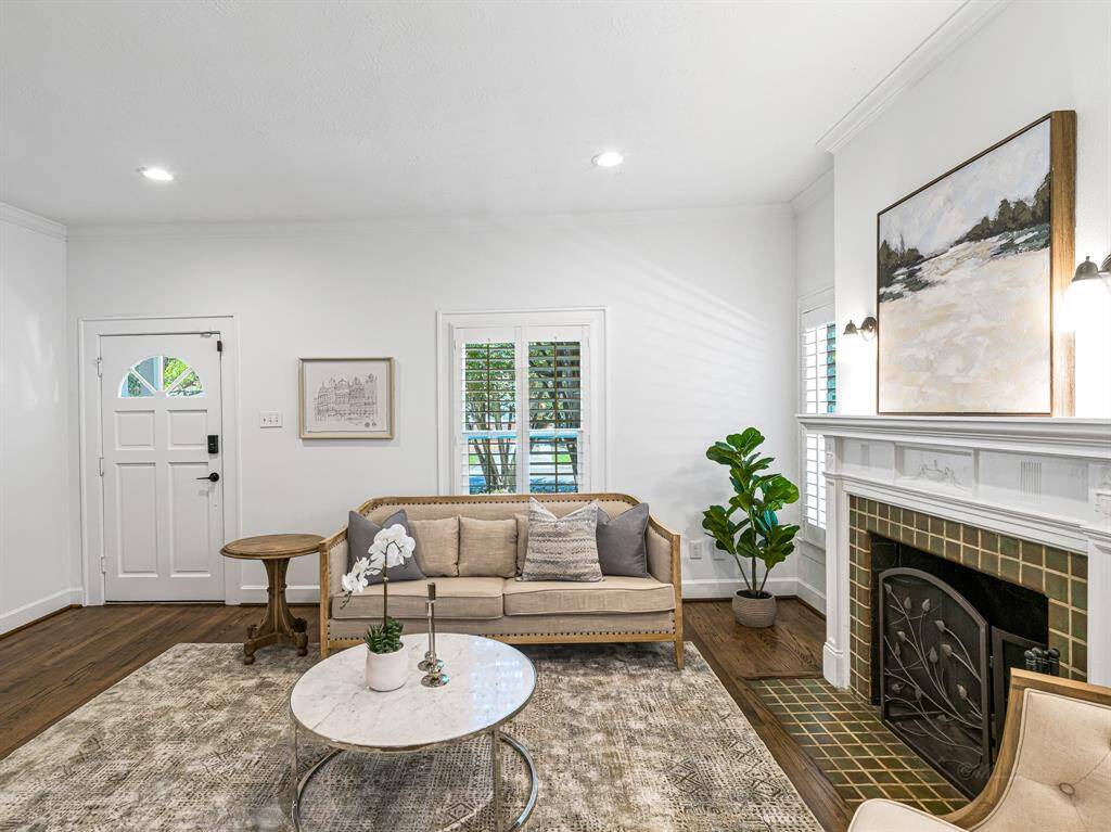 Recessed lighting and bright windows, dressed with plantation shutters, fill the space with natural light and warmth.