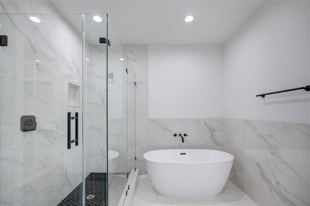 Primary has a soak-in tub and a nice frameless shower