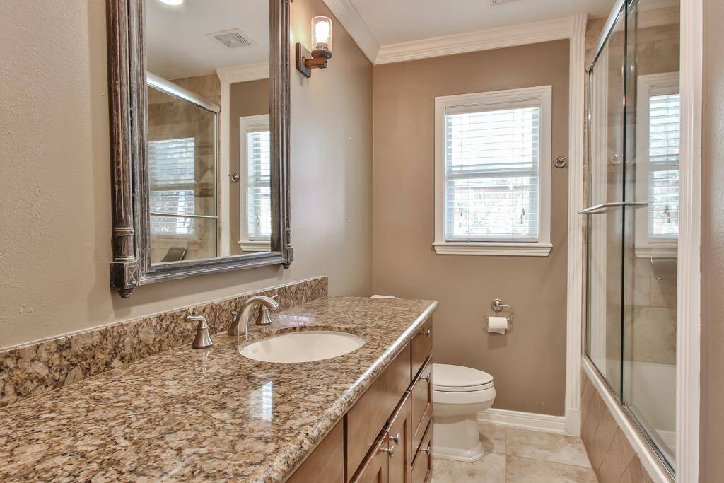First bathroom along the hallway near the bedrooms.