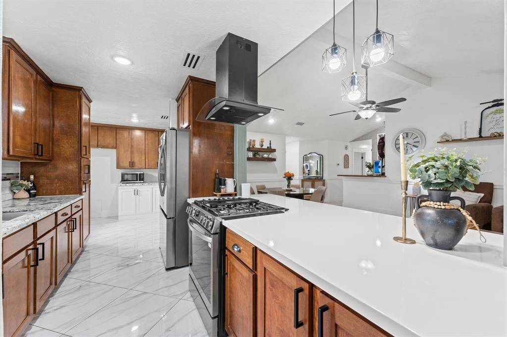 Fully upgraded kitchen with custom cabinets, large island, and ample counter space—ideal for cooking and entertaining.