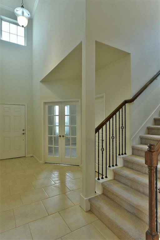 Experience grandeur with the soaring nearly 20-foot ceiling in the front entryway.