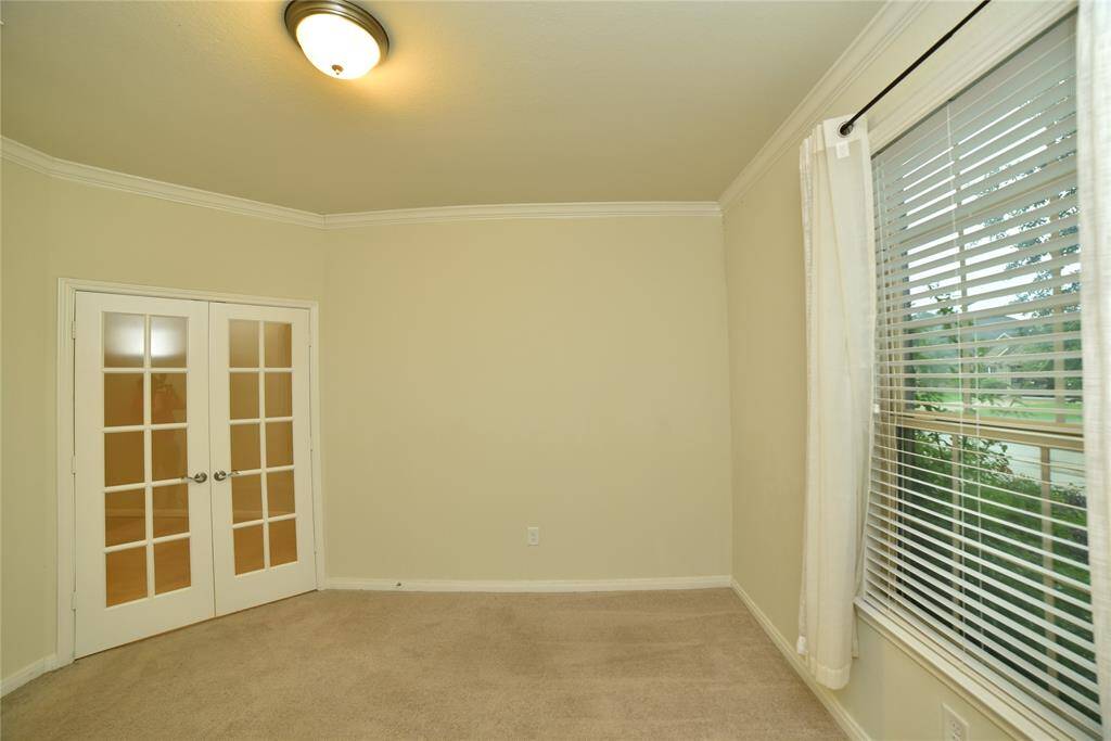 Elegant French doors with glass panels enhance the charm of this 12'11" x 11'4" home office, offering a stylish transition between spaces.