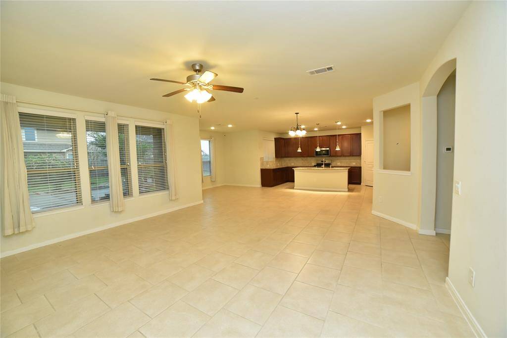Experience the airy, light-filled ambiance of this open floor plan seamlessly connecting the kitchen, dining, and living areas.