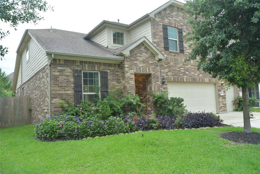 Left angle of the home with lush landscaping.