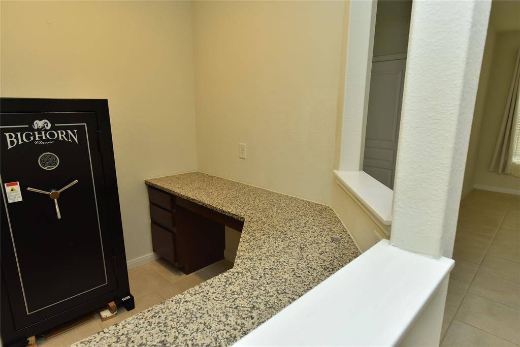 This built-in desk with a granite countertop offers functional and stylish workspace.