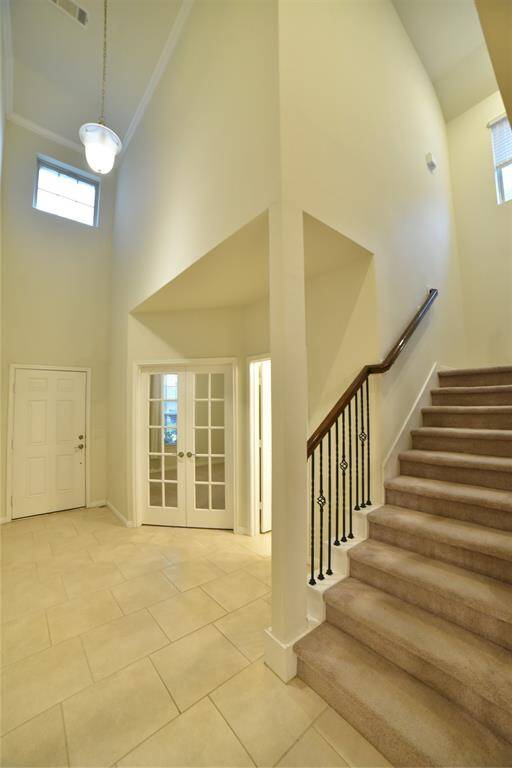 Ascend the elegant staircase to explore the inviting upper level.