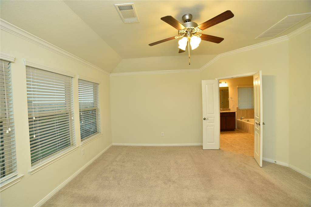 Spacious master bedroom (14'4" x 17'11") with ample natural light and adjoining ensuite bathroom.
