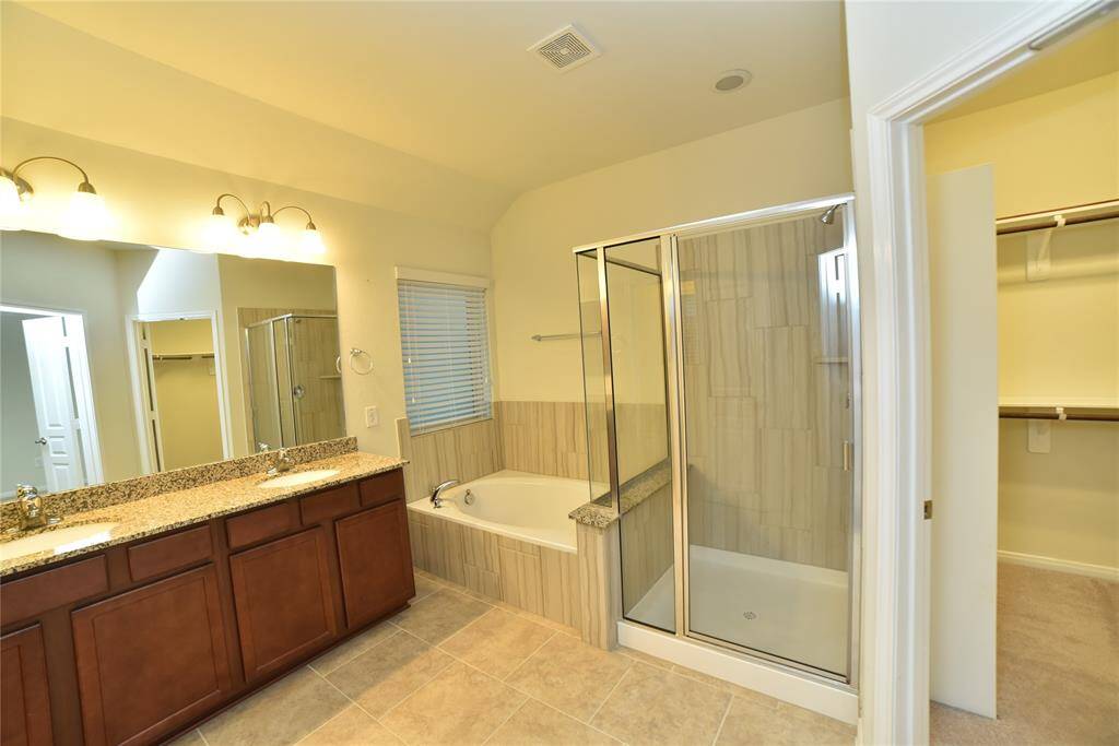 Spacious master bathroom with elegant double sinks, measuring 13'8" x 8'9".