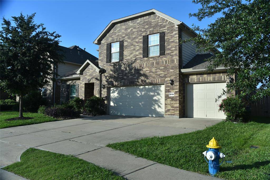 Right angle of the home with beautiful brick facade and spacious driveway.