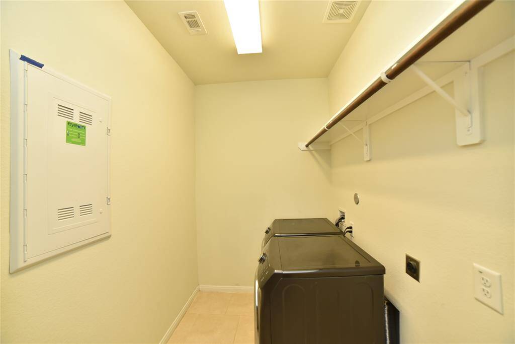 Laundry room (5'8"x9'8").  Compactwith overhead shelf and utility panel.