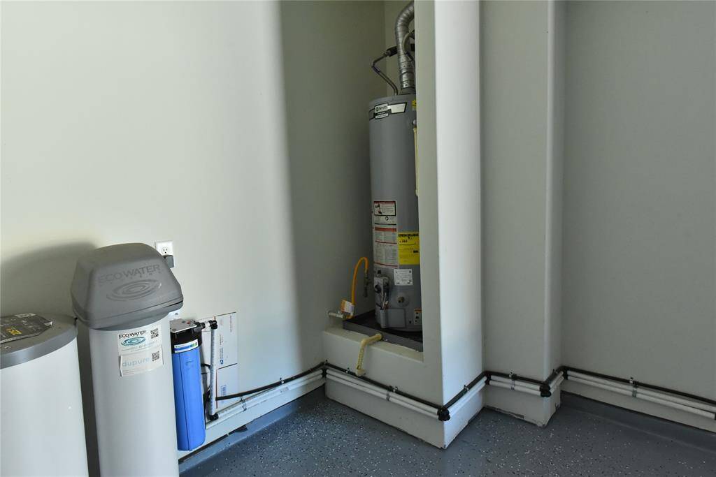 Water heater and water softener are in the garage.