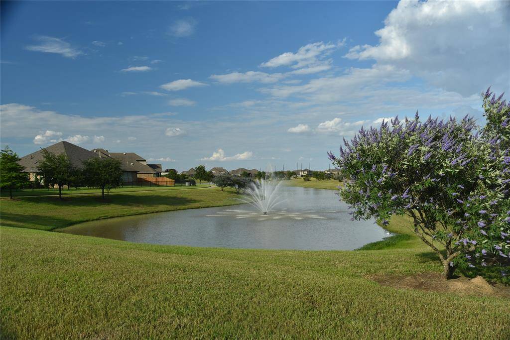 Many trees and ponds produce cooler and breeze into the subdivision.The landscape includes well-manicured lawns, mature trees, and a picturesque view of nearby homes, combining natural beauty with suburban tranquility.
