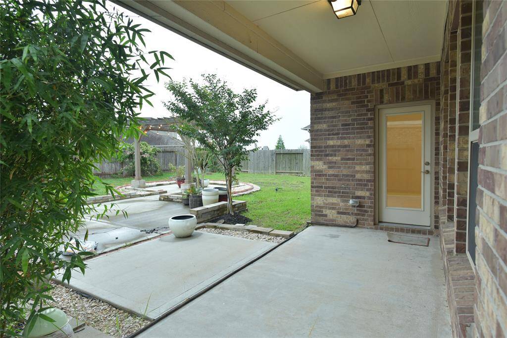 Experience tranquility in the afternoon breeze with this serene bamboo-lined patio.