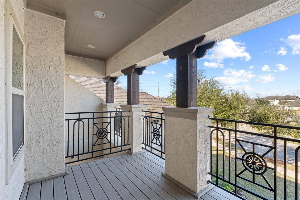 Second-floor balcony, offering a peaceful outdoor retreat with views of the serene neighborhood. The elegant design of the balcony adds a sophisticated touch to the home’s architecture, providing an ideal space for relaxing and enjoying the natural surroundings.