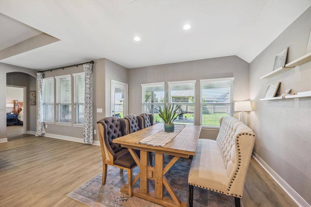 This bright and inviting dining area sits right off the kitchen and family room—perfect for casual meals or hosting guests. Just steps away, a nearby door leads straight to the large covered patio and sprawling backyard, making indoor-outdoor entertaining a breeze!