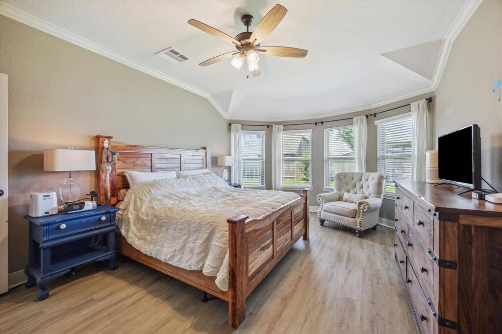 Wake up to beautiful backyard views through large windows that flood the room with natural light. This spacious primary suite is perfect for morning coffee or evening unwinding.