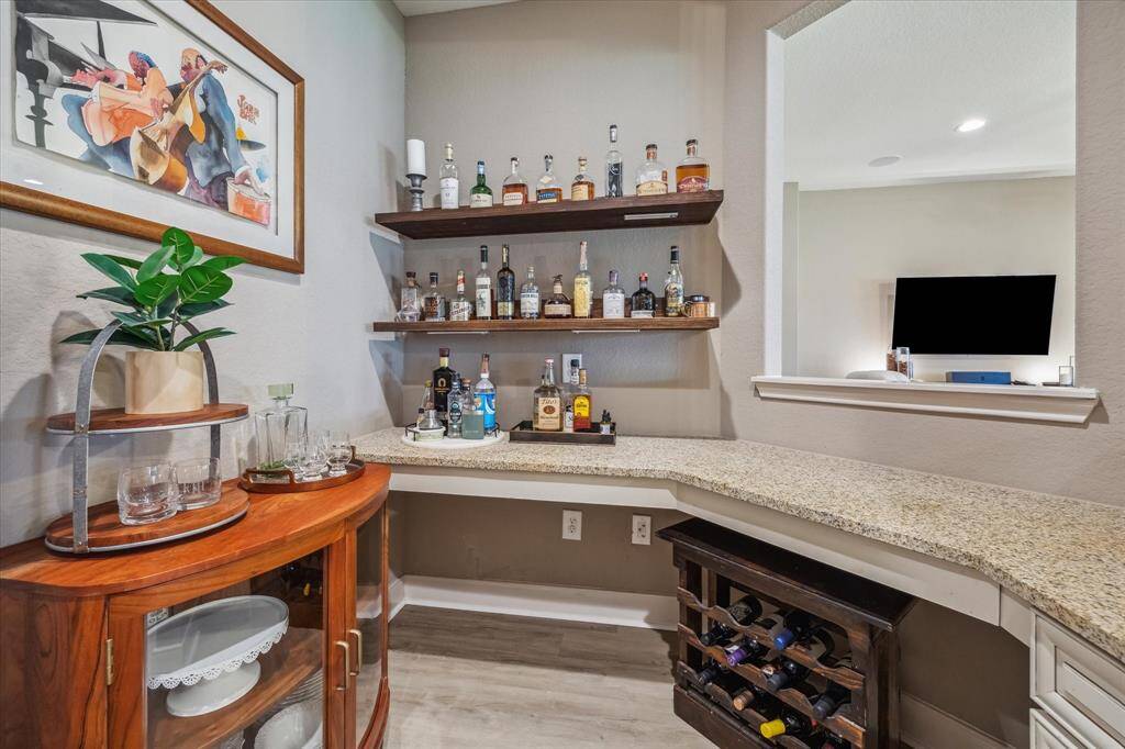 Conveniently located near the kitchen, this dry bar is perfect for serving drinks, displaying glassware, or creating your own coffee or cocktail station—ready to impress guests or elevate your everyday routine.
