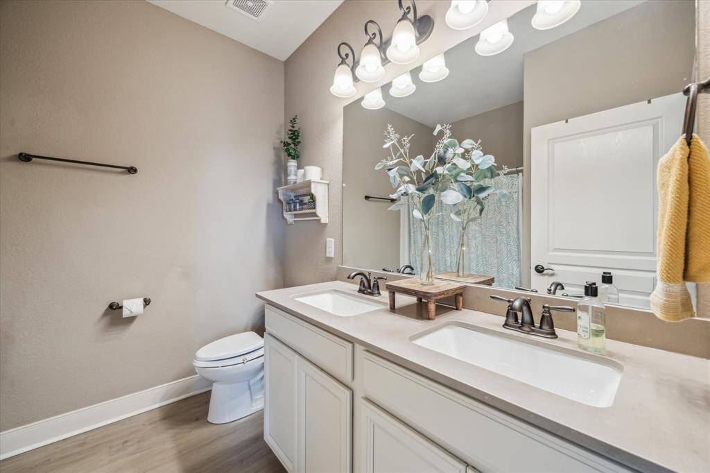 Designed for convenience, this shared bathroom features a double vanity—perfect for busy mornings or shared routines, with plenty of space and style for everyone.