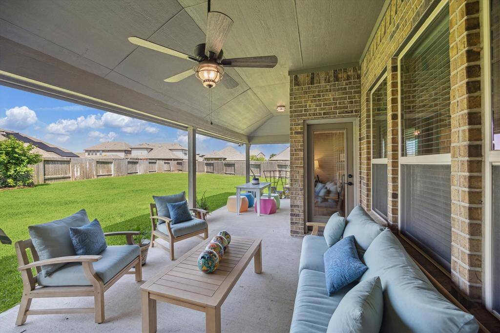 Relax and entertain in style with two separate sitting areas on this spacious covered patio, offering plenty of room to unwind or host guests while enjoying the beautiful backyard.