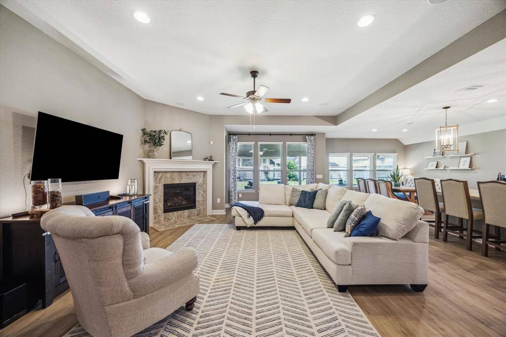 This inviting living space features an open layout. Natural light from windows, highlight the modern finishes and spacious design. This space is ideal for comfortable living and entertaining.