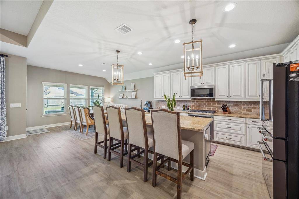 This spacious kitchen offers a large central island perfect for meal prep or casual dining.